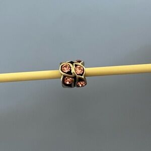 Chamilia sterling silver retired Paisley bead with pink cubic zirconia stones.